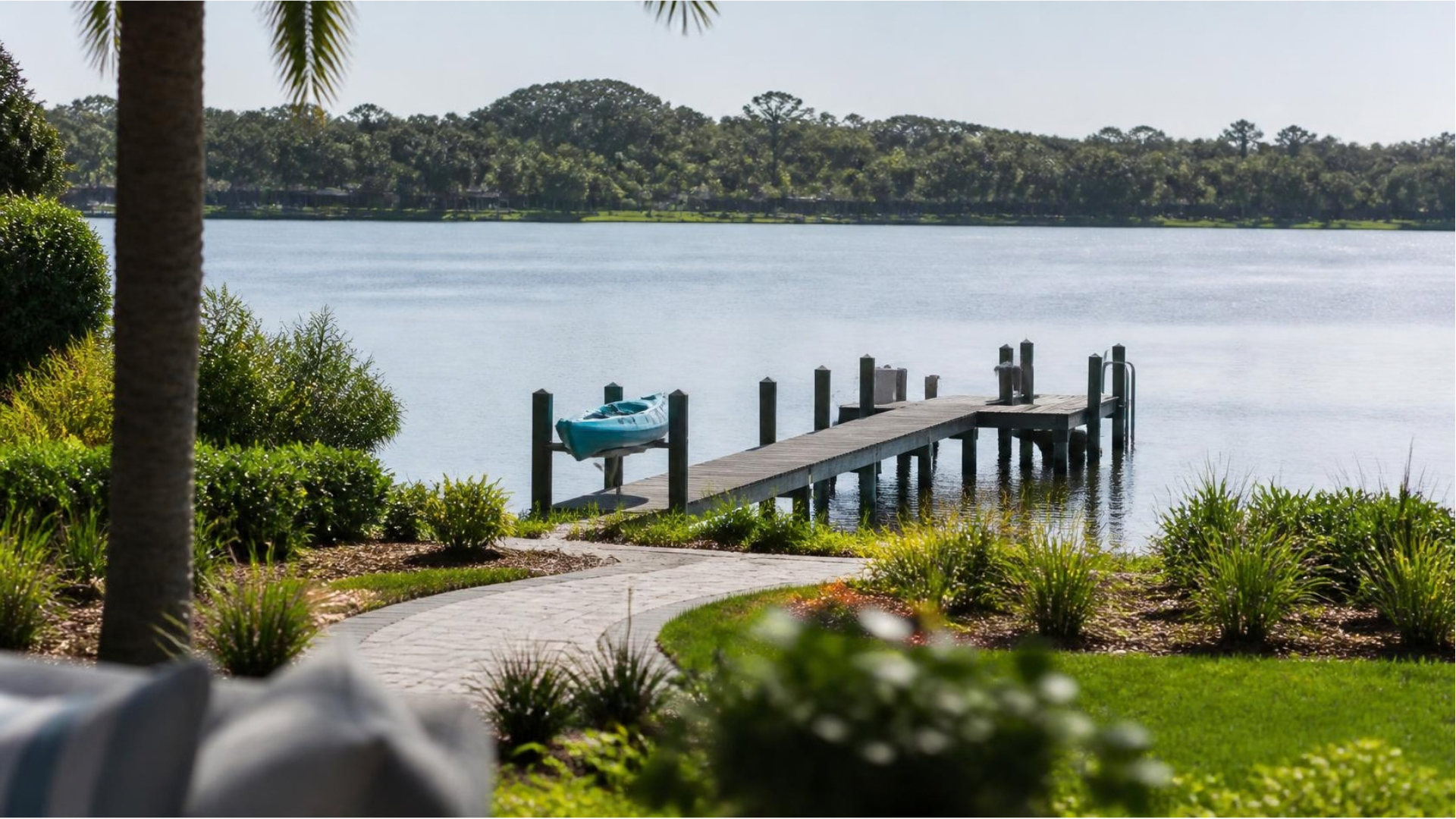 Lakefront home in Land O' Lakes, FL with a private boat dock overlooking calm water.